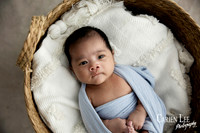 Newborn baby wrapped in soft blankets during Bunbury newborn photography session
