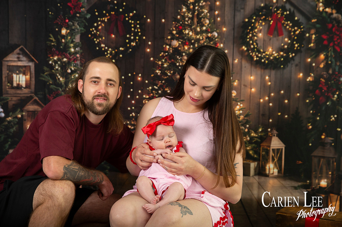 Family enjoying a Christmas mini session with Santa in a styled festive studio in Bunbury Western Australia
