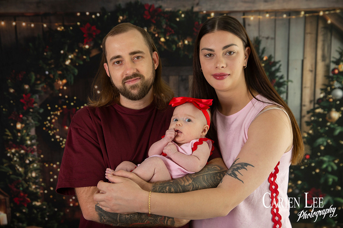 Family enjoying a Christmas mini session with Santa in a styled festive studio in Bunbury Western Australia