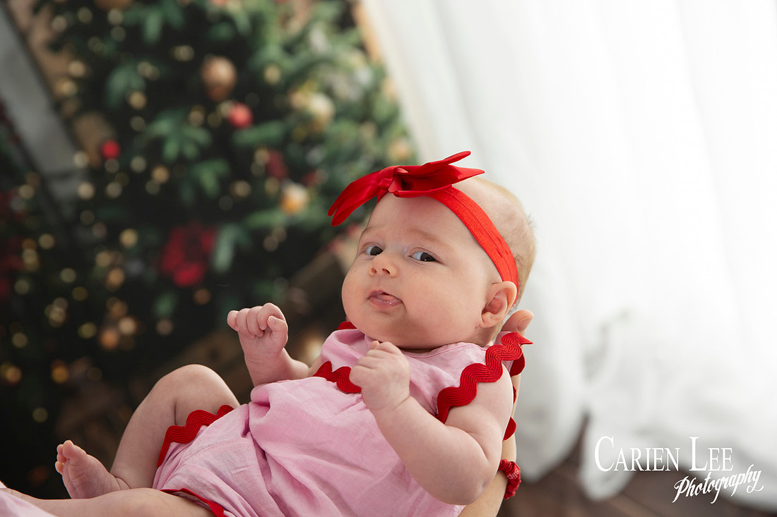Family enjoying a Christmas mini session with Santa in a styled festive studio in Bunbury Western Australia