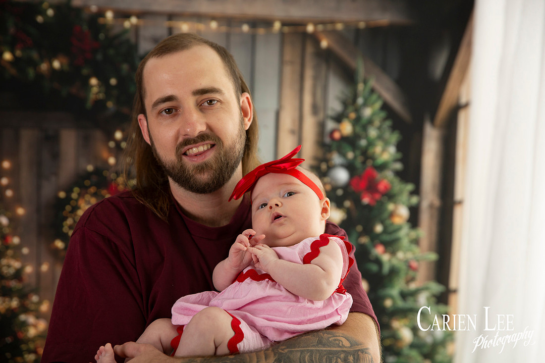 Family enjoying a Christmas mini session with Santa in a styled festive studio in Bunbury Western Australia