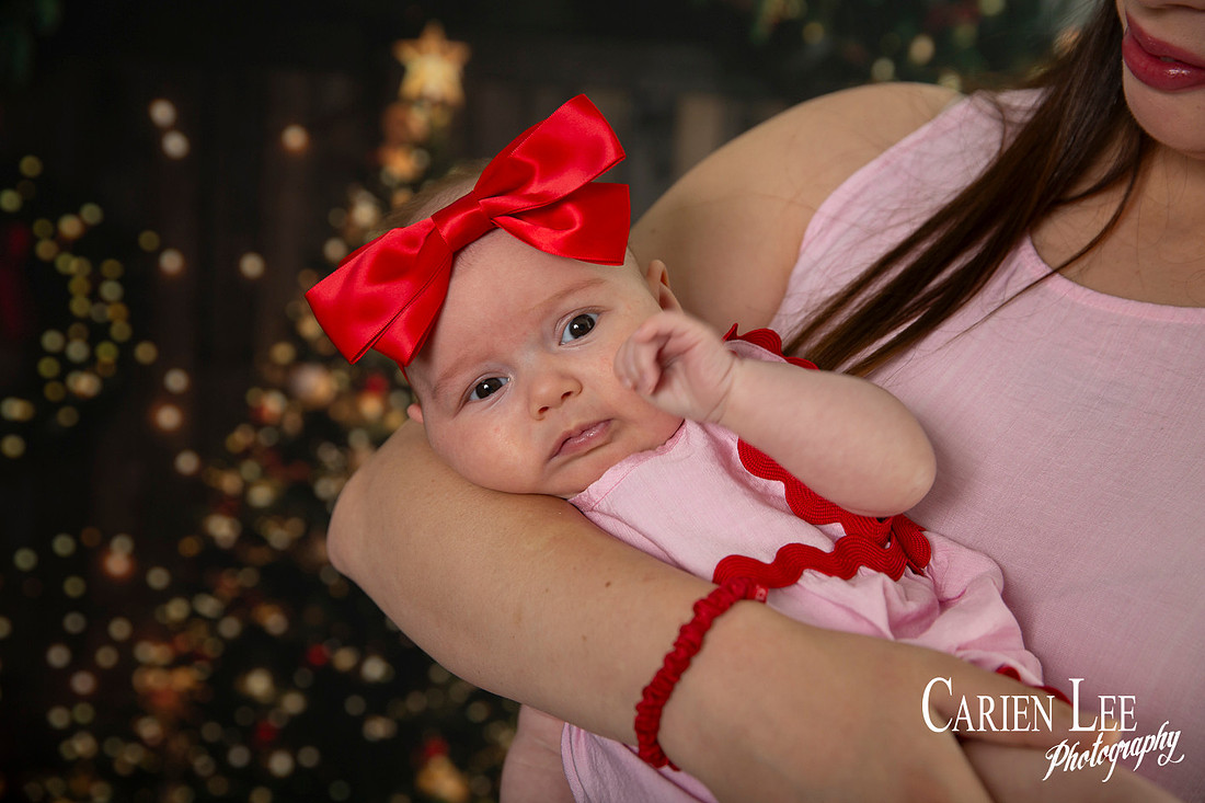 Family enjoying a Christmas mini session with Santa in a styled festive studio in Bunbury Western Australia