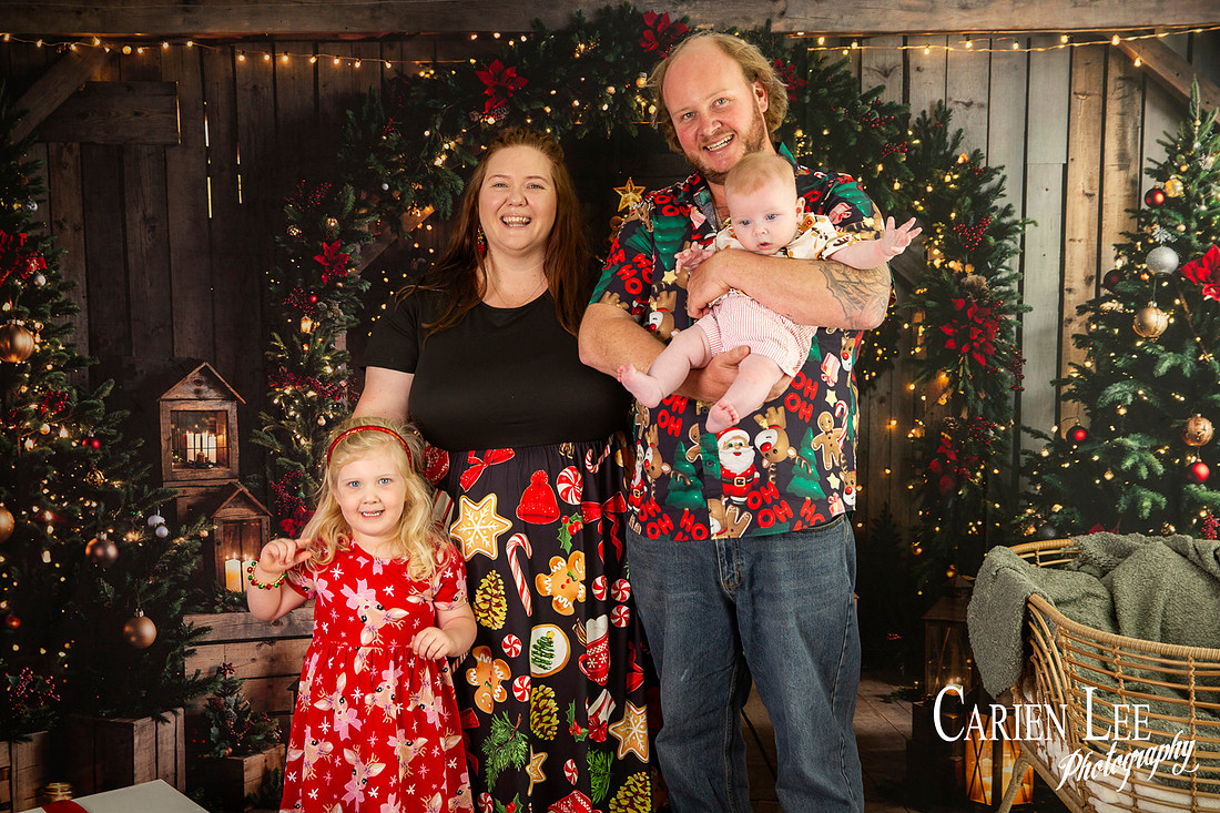 Family enjoying a Christmas mini session with Santa in a styled festive studio in Bunbury Western Australia
