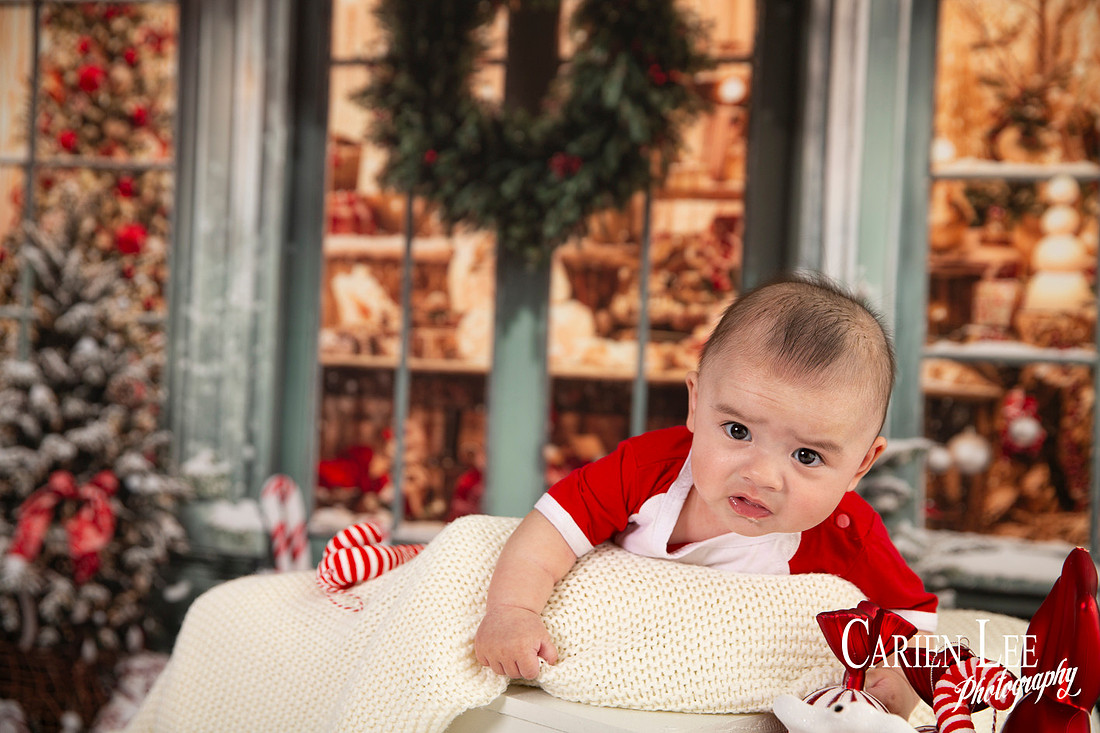 Family enjoying a Christmas mini session with Santa in a styled festive studio in Bunbury Western Australia