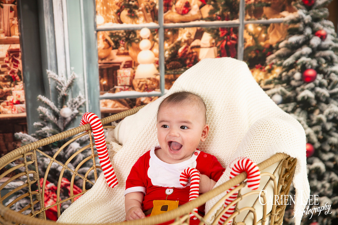 Family enjoying a Christmas mini session with Santa in a styled festive studio in Bunbury Western Australia