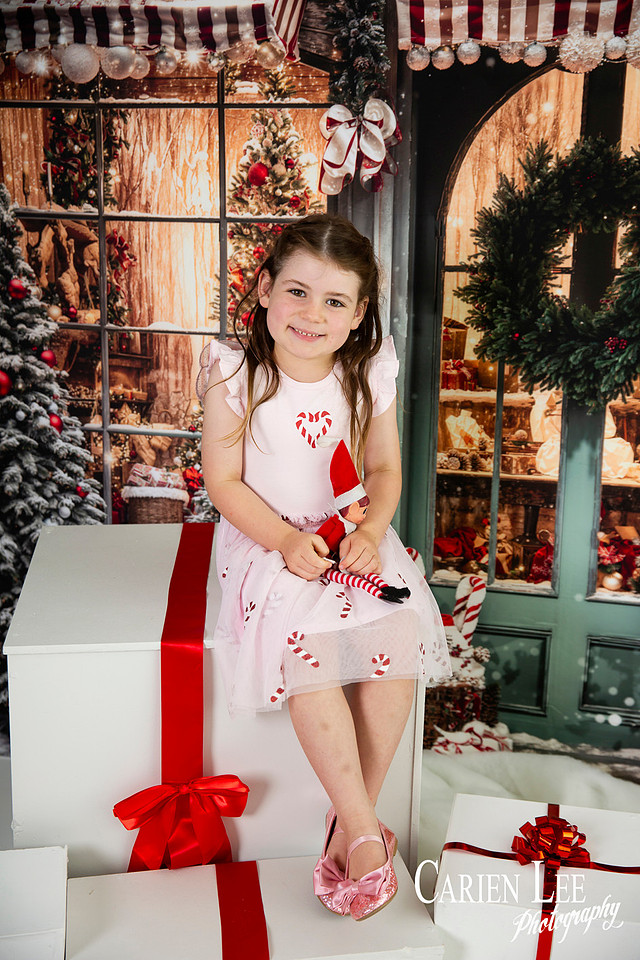 Family enjoying a Christmas mini session with Santa in a styled festive studio in Bunbury Western Australia