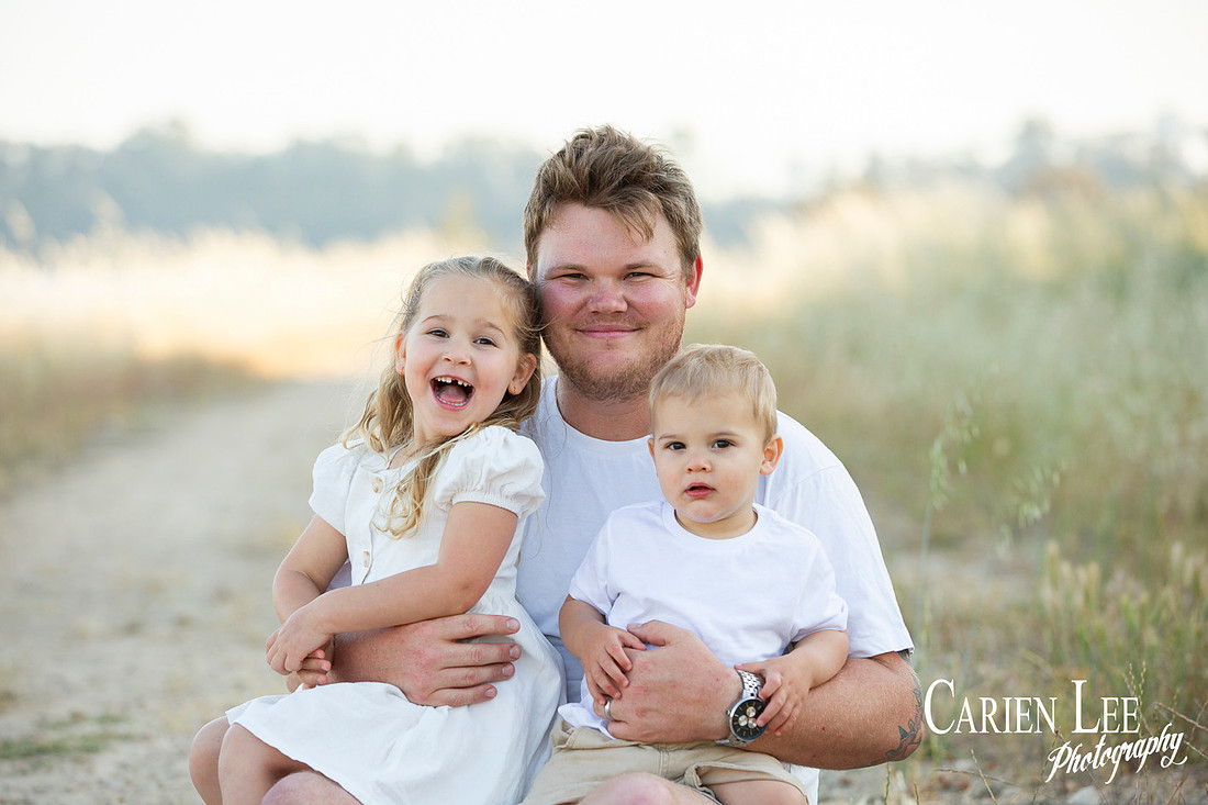 Family interacting naturally during a lifestyle photography session in Bunbury