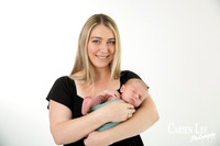 Newborn baby wrapped in soft blankets during Bunbury newborn photography session