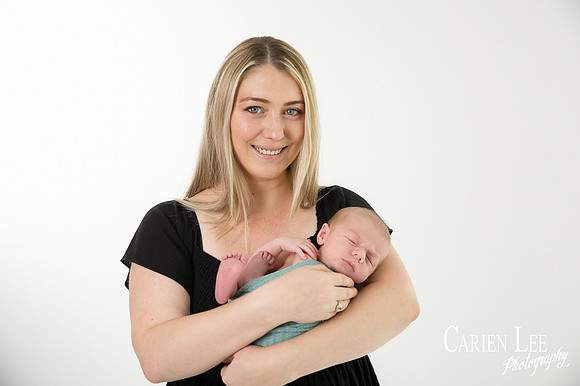 Newborn baby wrapped in soft blankets during Bunbury newborn photography session