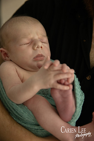 Newborn baby wrapped in soft blankets during Bunbury newborn photography session