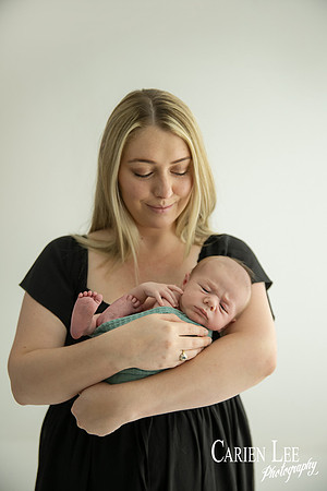 Newborn baby wrapped in soft blankets during Bunbury newborn photography session
