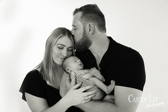 Newborn baby wrapped in soft blankets during Bunbury newborn photography session