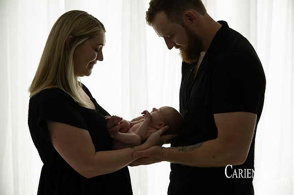 Newborn baby wrapped in soft blankets during Bunbury newborn photography session