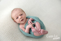 Newborn baby wrapped in soft blankets during Bunbury newborn photography session