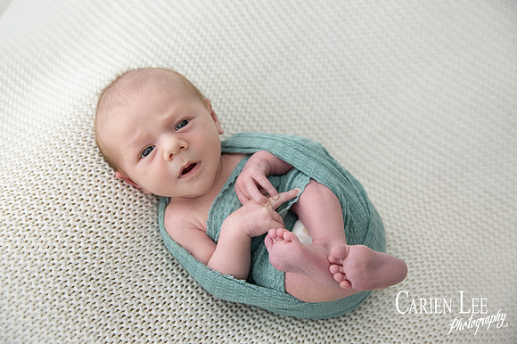 Newborn baby wrapped in soft blankets during Bunbury newborn photography session