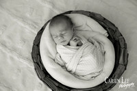 Newborn baby wrapped in soft blankets during Bunbury newborn photography session