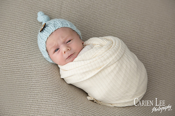 Newborn baby wrapped in soft blankets during Bunbury newborn photography session