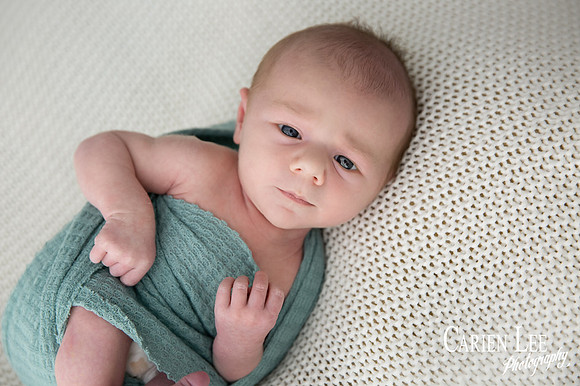 Newborn baby wrapped in soft blankets during Bunbury newborn photography session
