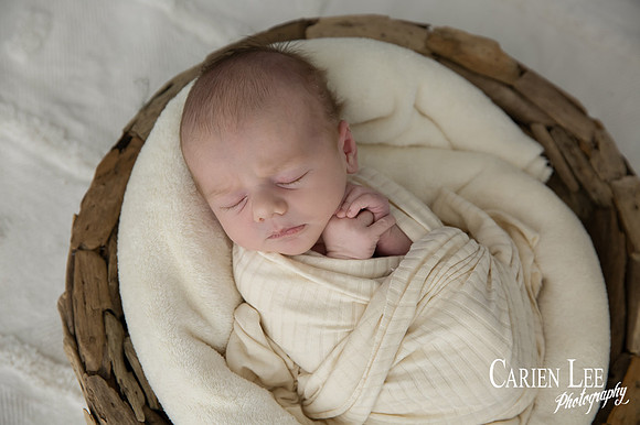 Newborn baby wrapped in soft blankets during Bunbury newborn photography session