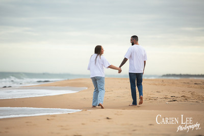 Engaged couple walking on bunbury back beach