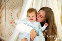 Mother cuddling her one-year-old daughter during a Mother’s Day studio session in Bunbury
