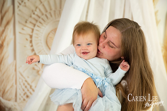 Mother cuddling her one-year-old daughter during a Mother’s Day studio session in Bunbury