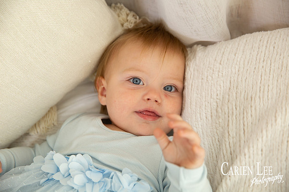 One-year-old girl smiling during motherhood photography session
