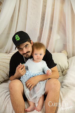 Mother and toddler daughter smiling together during studio family session