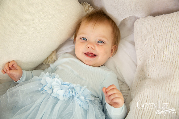 One-year-old girl smiling during motherhood photography session