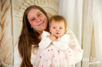 Mother and daughter embracing during timeless studio portrait session