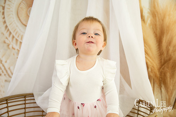 One-year-old girl smiling during motherhood photography session