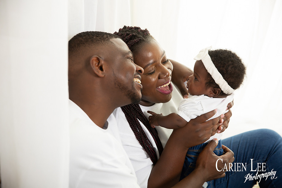 young parents with their 4 month old daughter during a family photo session in bunbury