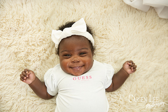 cute baby girl smiling for the camera in Bunbury studio