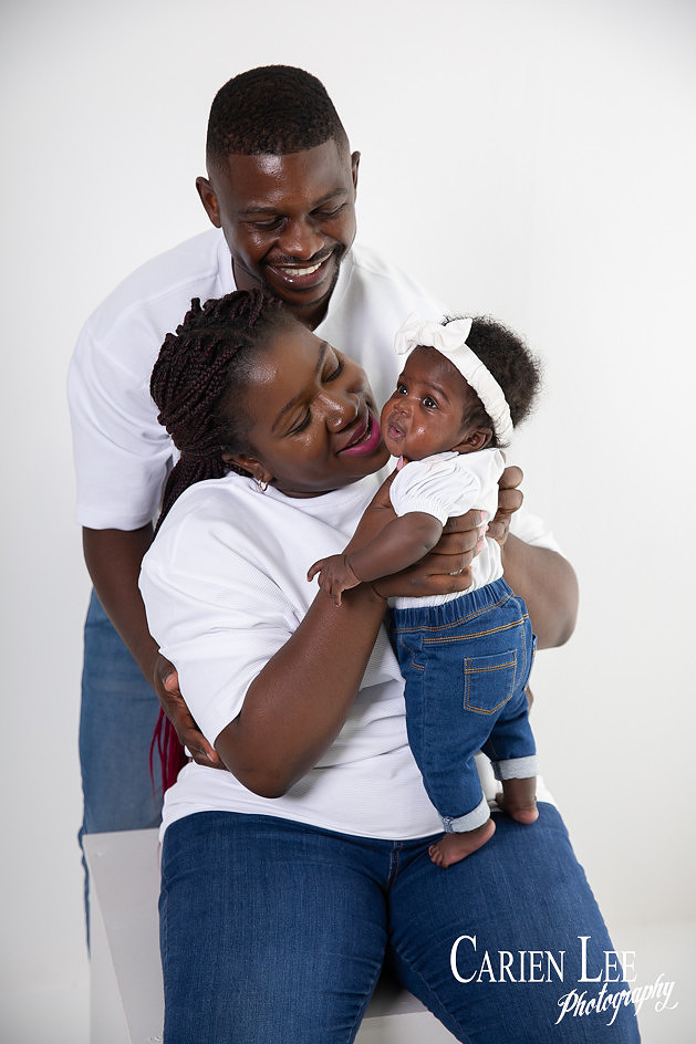 First time parents in studio with their 4 month old daughter