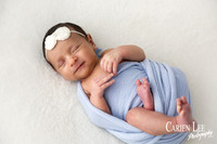 Newborn Girl secretly smiling during a newborn shoot in Bunbury