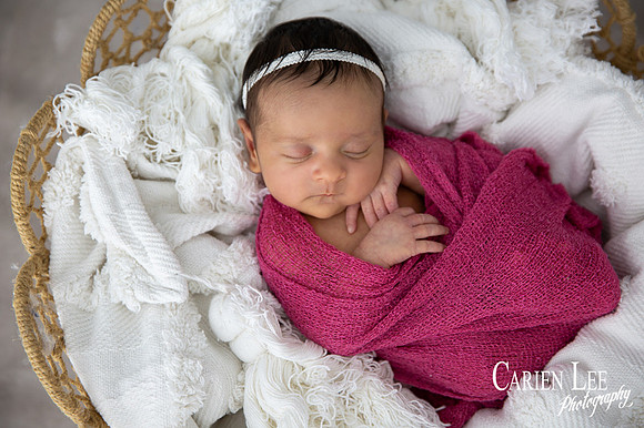 Baby girl peacefully sleeping during a  newborn session