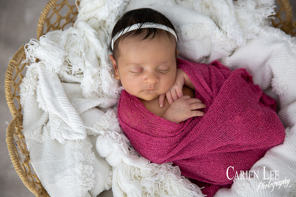 Baby girl peacefully sleeping during a  newborn session