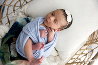 Newborn girl wrapped and cuddly in Bunbury Studio