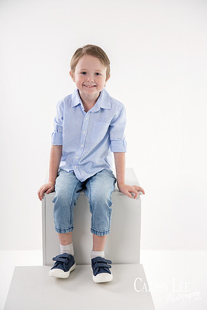 Photo of a young boy in timeless white studio