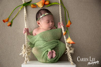 Newborn girl on a swing in a photography session in Bunbury