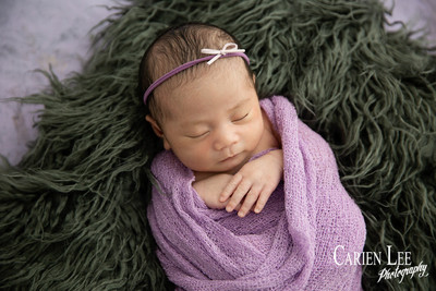 Newborn girl in Bunbury studio wrapped up in purple
