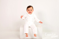Baby boy celebrating turning one with a blue and white themed milestone photo session
