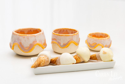 Commercial product photography highlighting handcrafted pottery in natural tones.