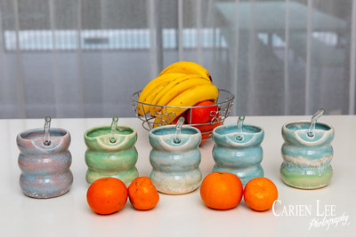 Commercial product photography highlighting handcrafted pottery in natural tones.