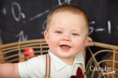 Baby boy in soft neutral outfit during children's milestone mini session