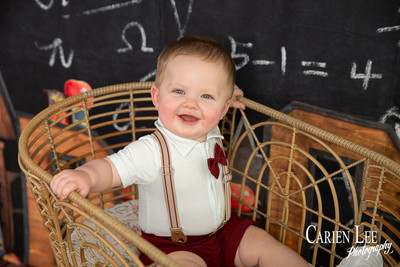 Baby milestone session photo showing Kai exploring textured backdrop