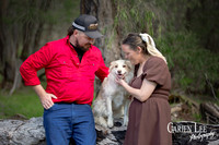 Couple's dog sitting between them during Bunbury pet-inclusive engagement shoot