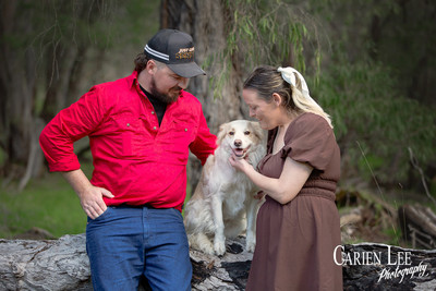 Couple's dog sitting between them during Bunbury pet-inclusive engagement shoot