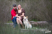 Couple embracing with their dog beside them during Bunbury photoshoot