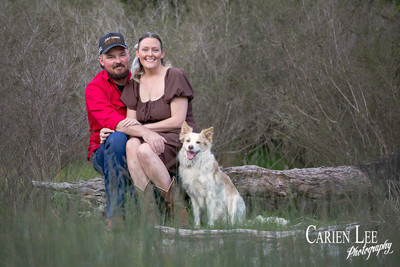 Couple embracing with their dog beside them during Bunbury photoshoot